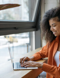 happy-african-american-woman-copywriter-working-freelance-project-from-home-businesswoman-using-laptop-searching-information-website-successful-business-online-training-courses-concept-scaled