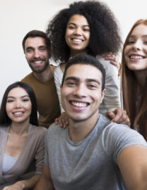 group-happy-young-people-taking-selfie-scaled